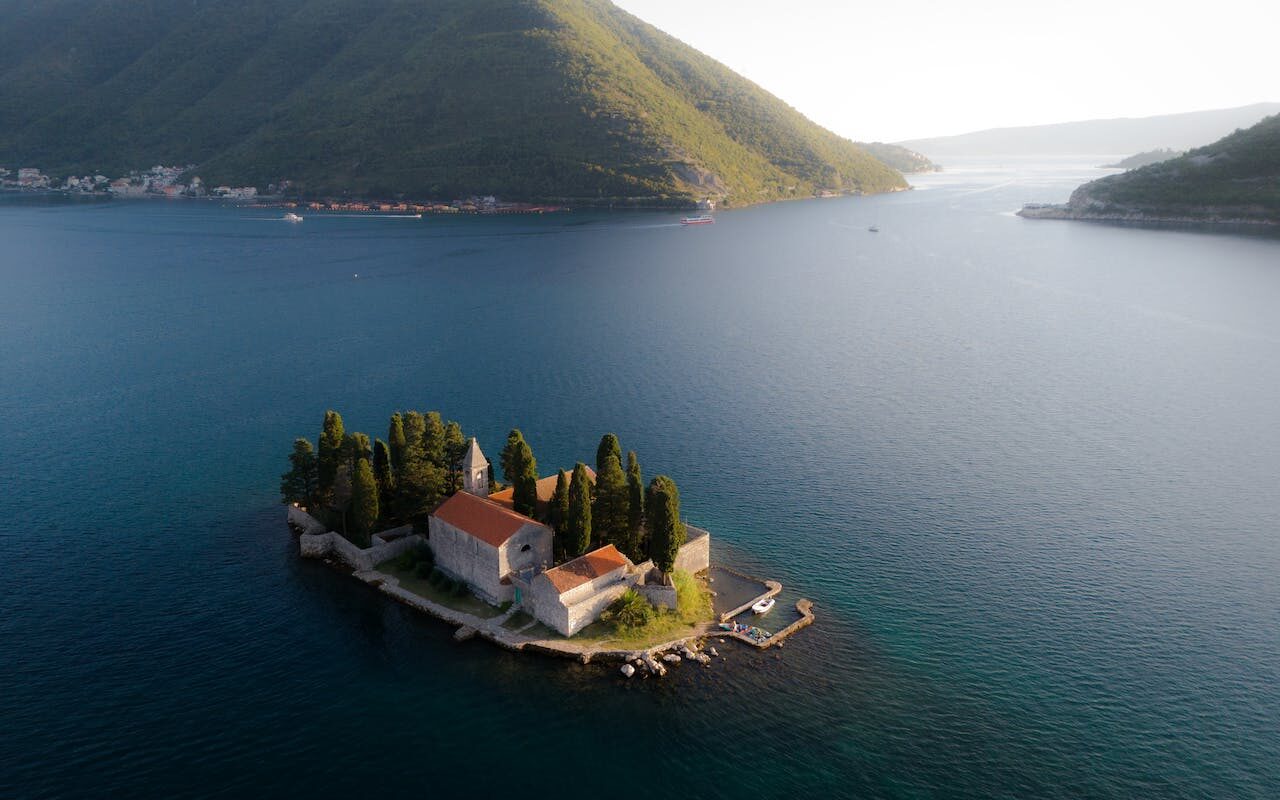 image source Photo by Ivan Glusica: https://www.pexels.com/photo/islet-with-saint-juraj-monastery-in-bay-of-kotor-18573341/