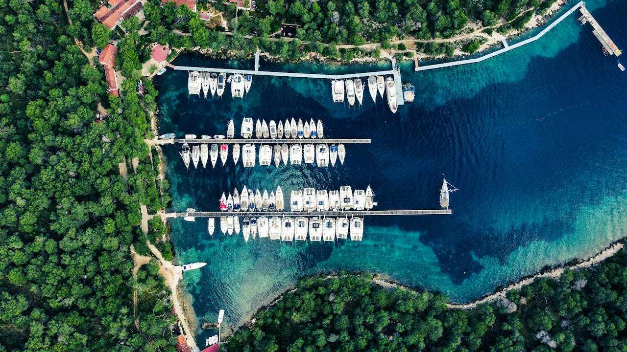 image source Photo by Stefan Prutsch: https://www.pexels.com/photo/aerial-view-of-the-marina-with-fully-moored-yachts-18585883/