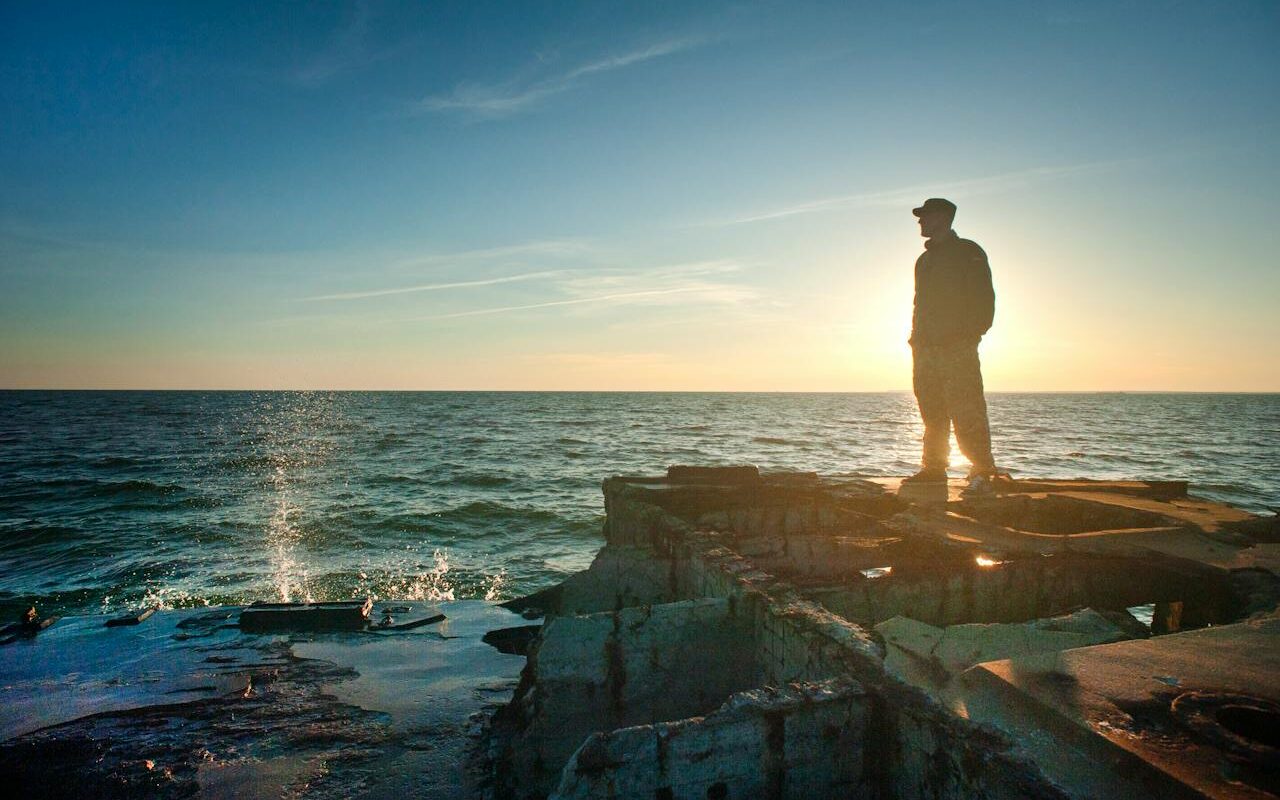 image source Photo by Oleksandr P: https://www.pexels.com/photo/silhouette-photo-of-man-standing-near-the-edge-of-concrete-pavement-1060492/