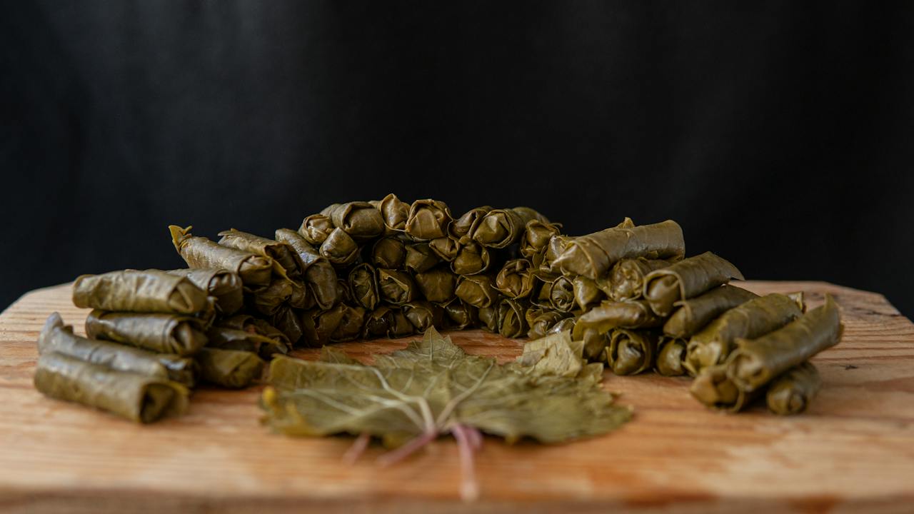 image source Photo by tugay aydın: https://www.pexels.com/photo/dolma-rolls-near-grape-leaf-on-table-5626936/